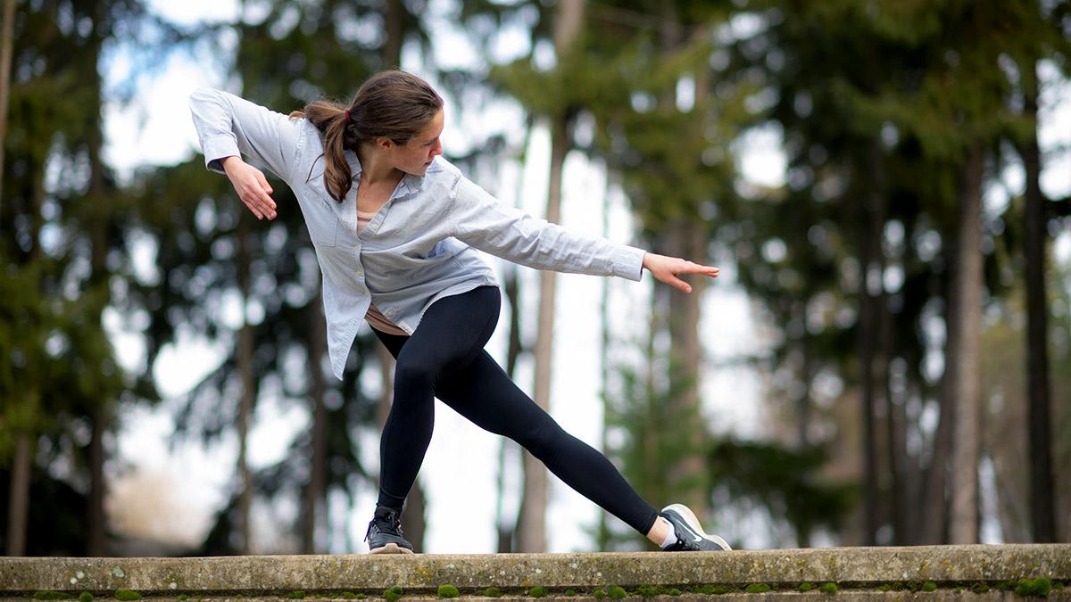 Two women dance on the steps of an outdoor amphitheater.