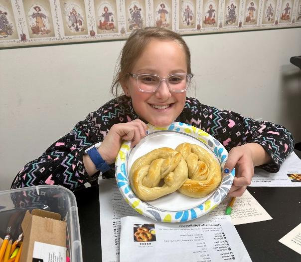 kid holding a pretzel 