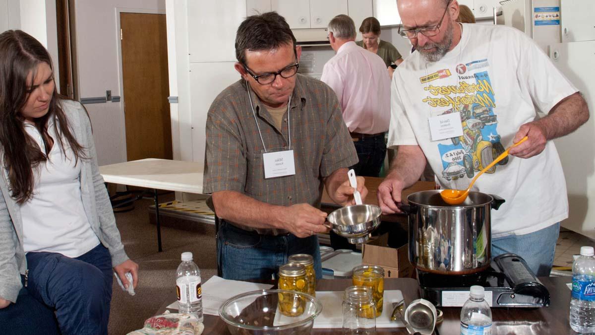 A group learning how to can and preserve food